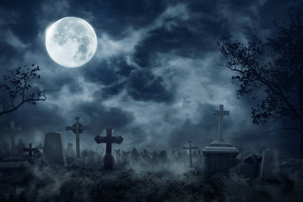 Zombie+Rising+Out+Of+A+Graveyard+cemetery+In+Spooky+dark+Night+full+moon.+Holiday+event+halloween+concept.